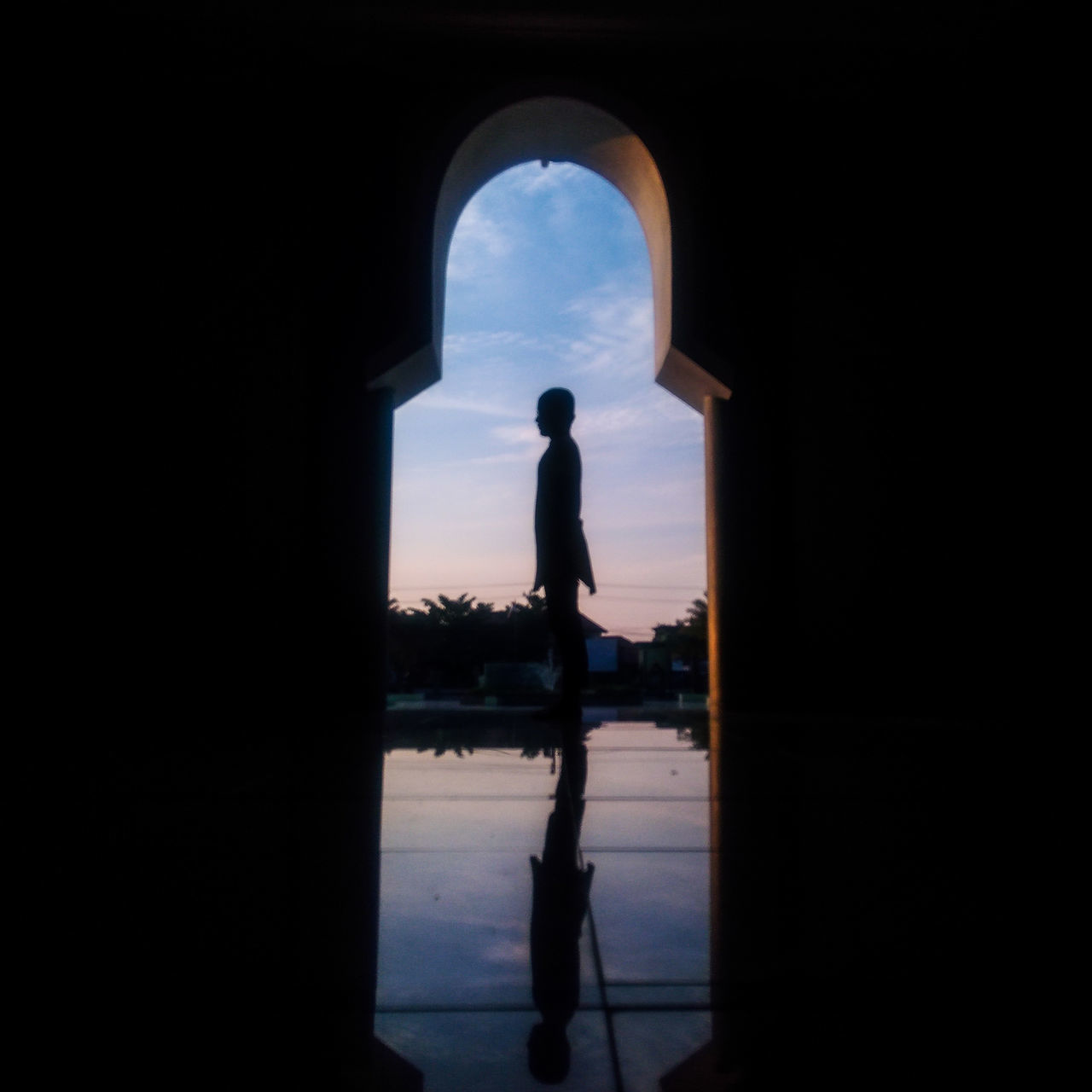 SILHOUETTE OF WOMAN LOOKING AT VIEW OF WATER