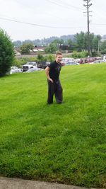 Full length of girl standing on grassy field