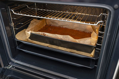 Baking tray with raw dough in the oven ready for baking.