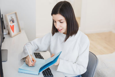 Young woman using laptop at home