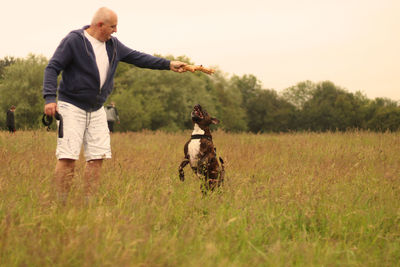 Man with dog on field