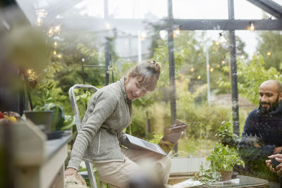 Smiling woman in greenhouse