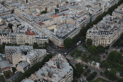 Paris, france from the eiffel tower. high angle view of buildings in city against cloudy sky