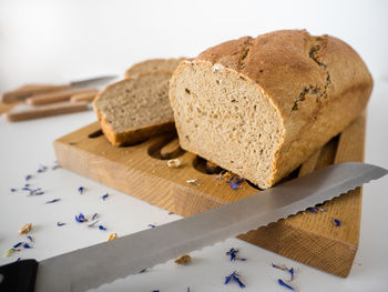 Close-up of bread and knife on wood