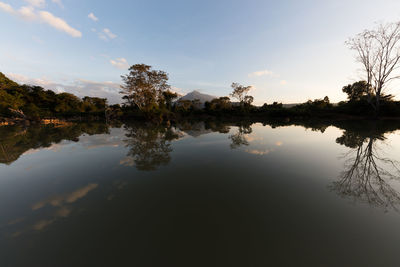 Scenic view of lake against sky at sunset