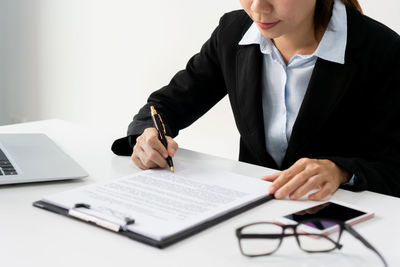 Midsection of businessman working at desk in office