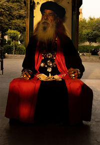 Portrait of man sitting in red hat