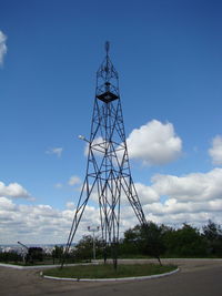 Low angle view of communications tower against sky