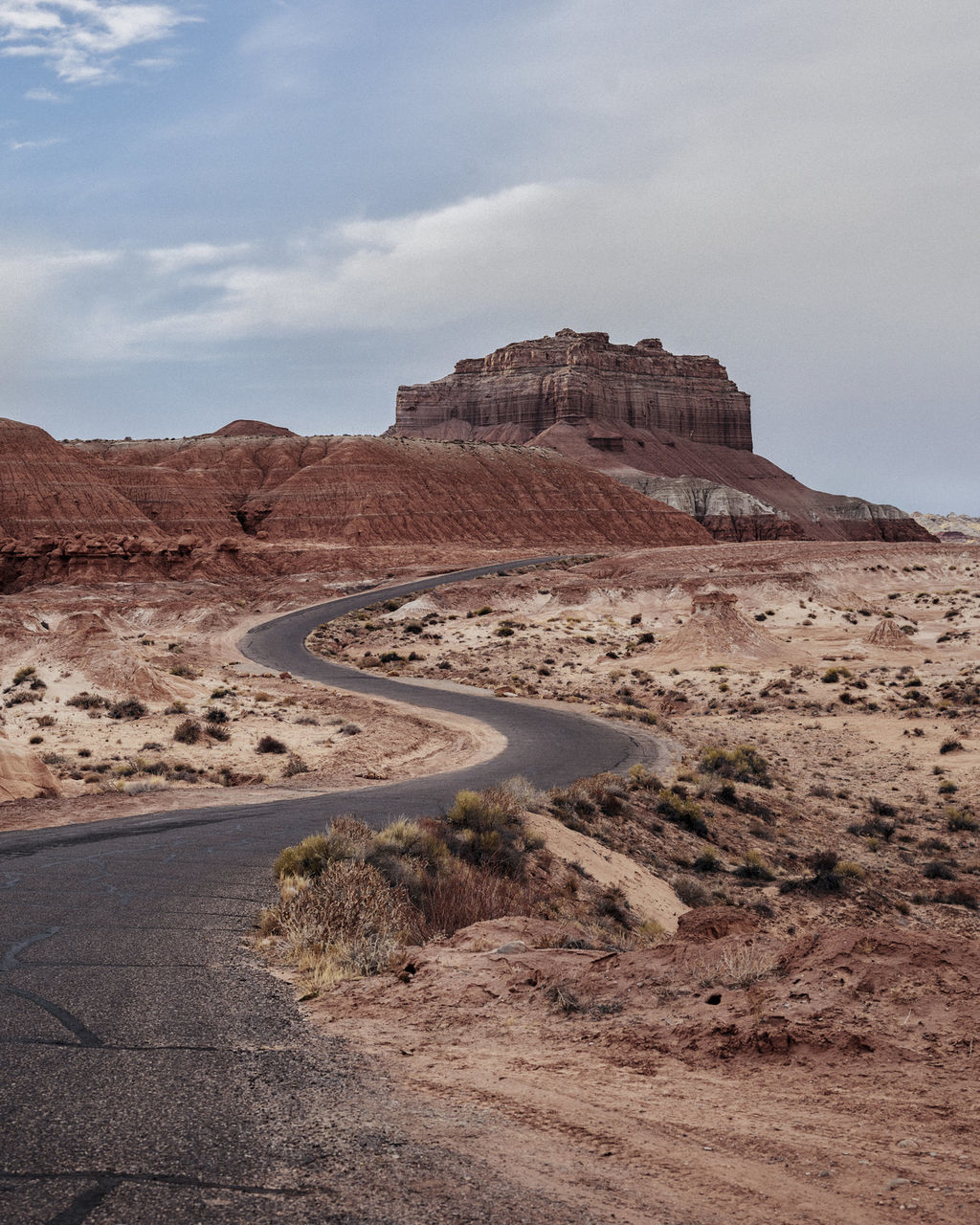 sky, environment, landscape, tranquil scene, nature, scenics - nature, road, day, non-urban scene, tranquility, beauty in nature, land, no people, cloud - sky, mountain, rock formation, physical geography, rock, rock - object, desert, climate, outdoors, arid climate