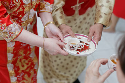 Midsection of woman holding ice cream