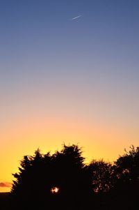 Low angle view of silhouette trees against sky during sunset