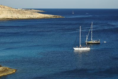 Sailboat on sea against sky