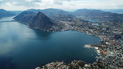 High angle view of sea and mountains against sky