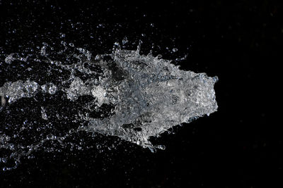 Close-up of water splashing on black background