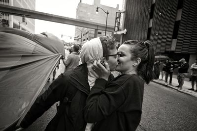 Side view of couple kissing outdoors