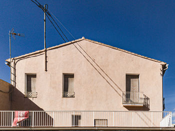 Low angle view of building against clear blue sky