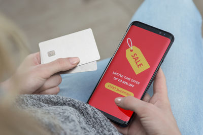 Close-up of woman hand holding mobile phone