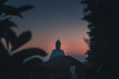 Silhouette of building against sky during sunset