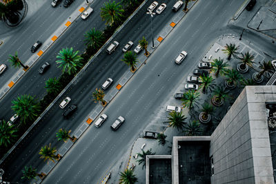 High angle view of cars on road by building in city