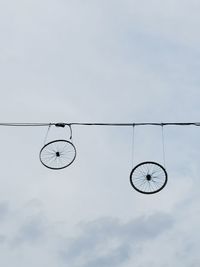 Low angle view of bicycle against cloudy sky