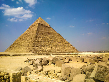 Pyramid in desert against blue sky