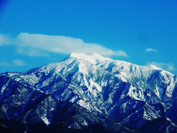 Scenic view of snow covered mountains against sky