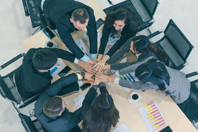 High angle view of people sitting on table