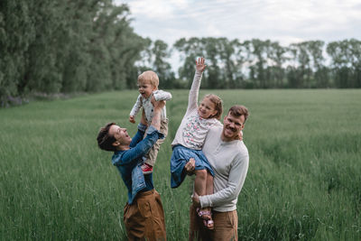 Full length of father and daughter on field