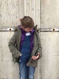 Girl standing against wall