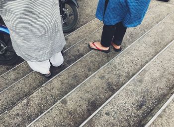 Low section of woman standing on tiled floor