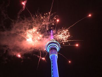 Low angle view of firework display at night