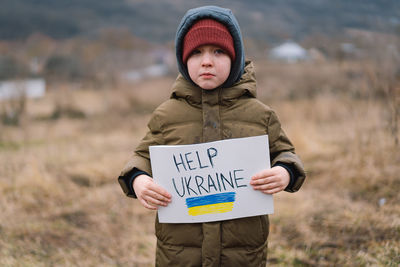 War of russia against ukraine. crying boy asks to stop the war in ukraine.