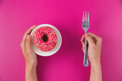 Cropped hands of woman holding coffee on table