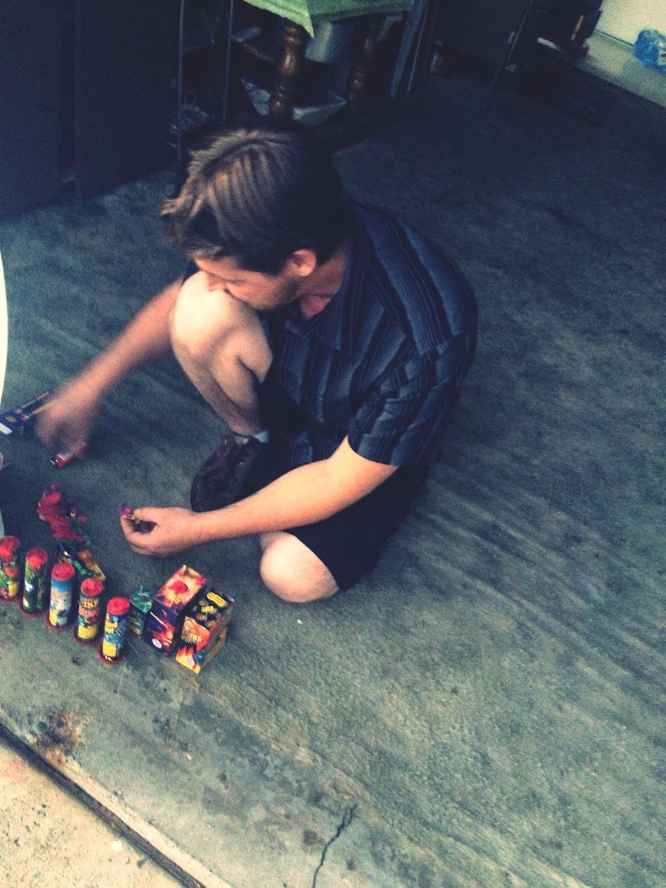 HIGH ANGLE VIEW OF BOY PLAYING ON FLOORING