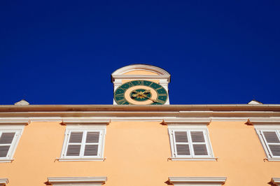 Low angle view of clock tower against clear sky