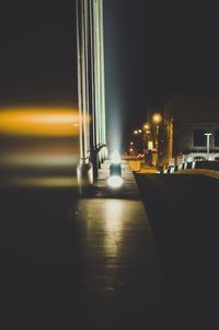 Illuminated road in city at night