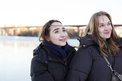 Smiling female couple in winter scenery