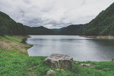 Scenic view of lake and mountains against sky