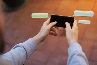 Midsection of man using mobile phone