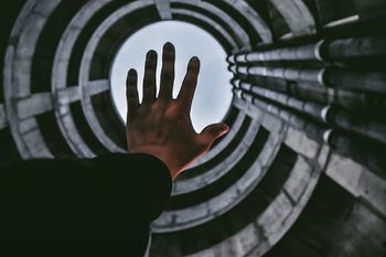 CLOSE-UP OF HUMAN HAND ON LEAF