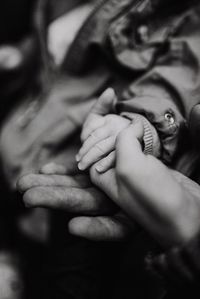 Close-up of couple holding hands