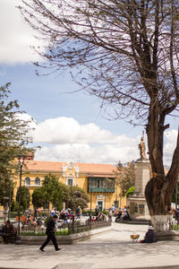 Street by buildings in city against sky