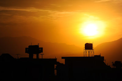 Silhouette building against sky during sunset