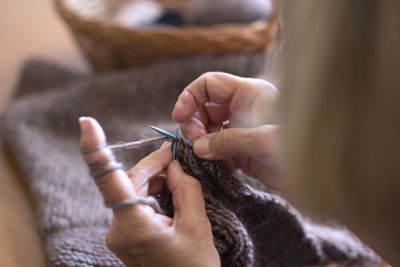 Cropped image of hands knitting wool