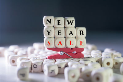 Close-up of text with clothespin on blocks over table