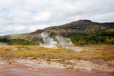 Scenic view of geothermal landscape against sky