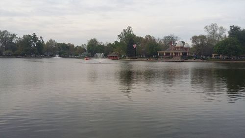 Scenic view of river against cloudy sky