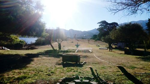 Scenic view of field against sky on sunny day