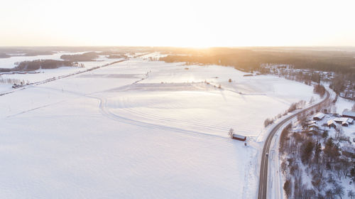 Snow covered landscape against clear sky