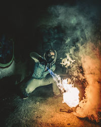 Full length of young man performing stunt with fire